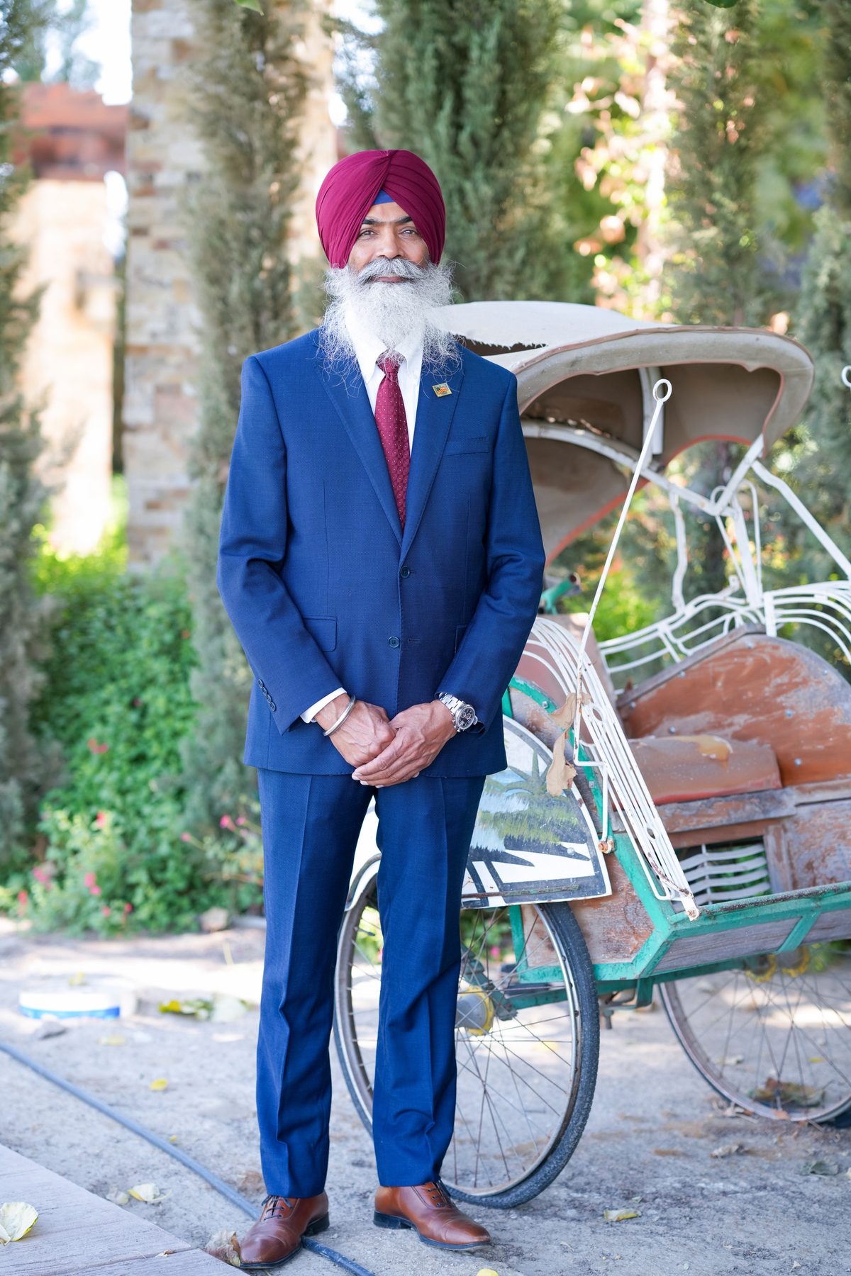 Gurjant Singh Khosa standing beside a vintage cycle rickshaw